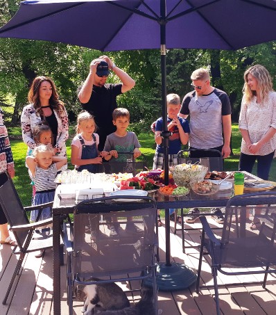 Farmer family eating outside on the patio