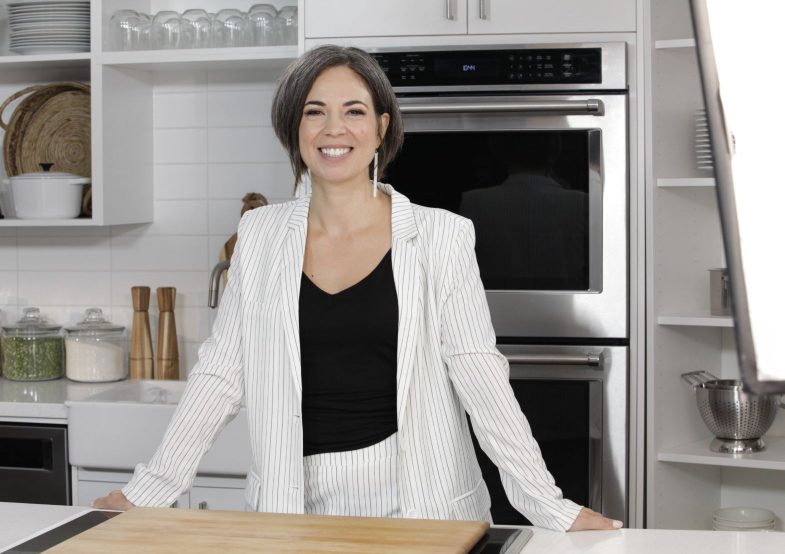 Cooking Show Host poses in kitchen
