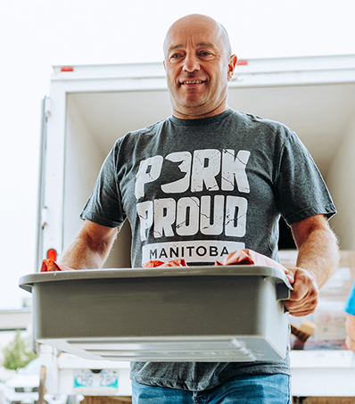 Pork Farmer carrying pork into food bank