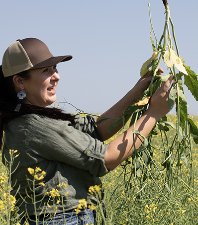Erin Jackson holding canola plant